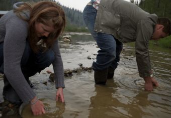 man and woman looking for Gold in the river