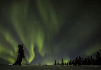 Person looking up at northern lights